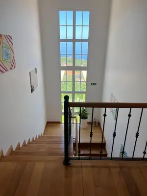 a hallway with a staircase with a large window at Spring House AL in Arco da Calheta