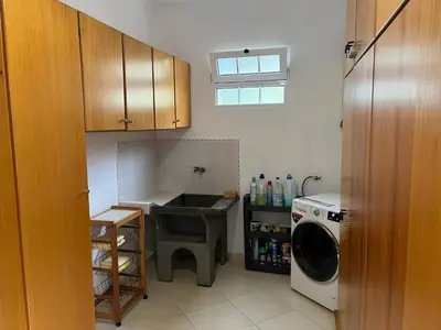 a kitchen with a sink and a washing machine at Spring House AL in Arco da Calheta