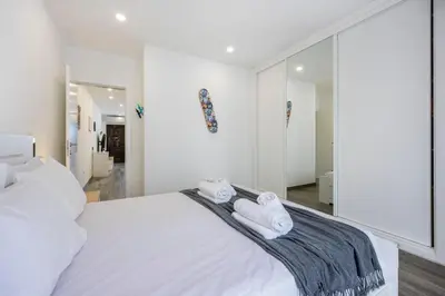 a bedroom with a white bed with towels on it at Waterside Village - Oceanview Dream in Luz
