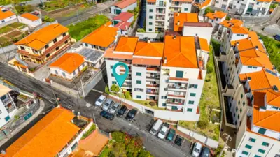 an overhead view of a city with orange roofs at Cozy Seaside Apartment Near Beach and Airport in Caniço