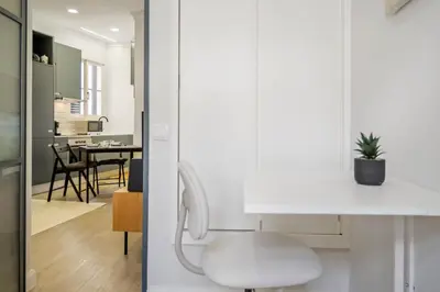 a living room and dining room with a white chair at Ponte Nova Studios in Funchal