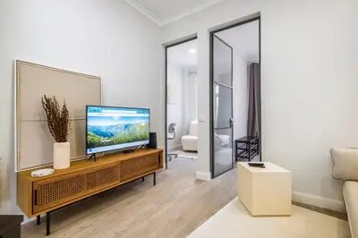 a living room with a flat screen tv on a table at Ponte Nova Studios in Funchal