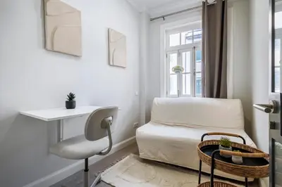a room with a bed and a chair and a window at Ponte Nova Studios in Funchal