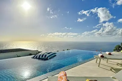 a swimming pool with a view of the ocean at Villa OceanAIR by LovelyStay in Prazeres