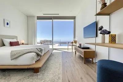 a bedroom with a bed and a view of the ocean at Villa OceanAIR by LovelyStay in Prazeres