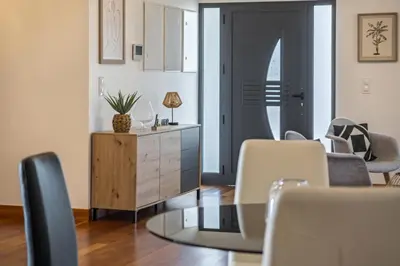 a living room with a table and chairs at Faias Haven by Homie in Arco da Calheta