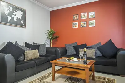 a living room with a couch and a table at Faias Haven by Homie in Arco da Calheta