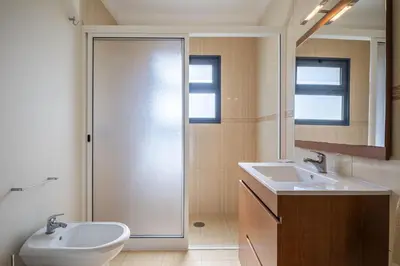 a bathroom with two sinks and a shower at Faias Haven by Homie in Arco da Calheta