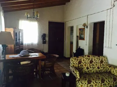 a living room with a couch and a table at Moinho do Comandante in Faial
