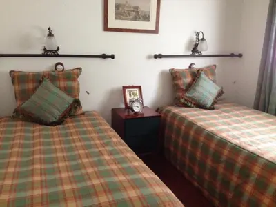 two beds sitting next to each other in a room at Moinho do Comandante in Faial