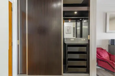 a closet with a wooden door in a room at Costa Apartment II - Linda Vista in Caniço