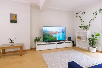 a living room with a flat screen tv on a white cabinet at Brava Home - Best Location to Explore Madeira in Ribeira Brava