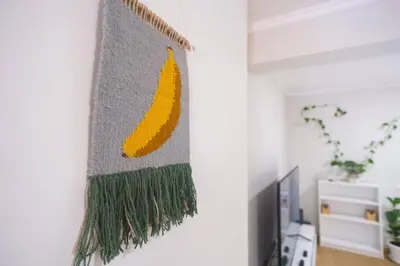 a wall hanging of a pineapple rug on a wall at Brava Home - Best Location to Explore Madeira in Ribeira Brava