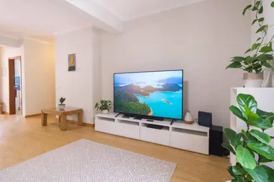 a living room with a flat screen tv on a white wall at Brava Home - Best Location to Explore Madeira in Ribeira Brava