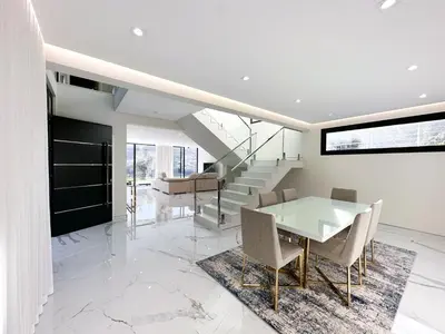 a dining room with a glass table and chairs at Villa Montana in São Vicente