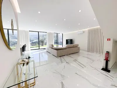 a living room with a couch and a mirror at Villa Montana in São Vicente