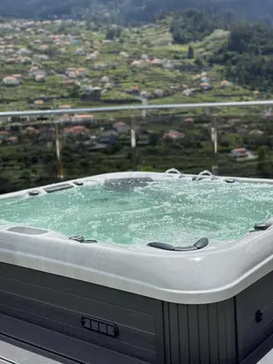 a jacuzzi tub with a view of a city at Villa Montana in São Vicente
