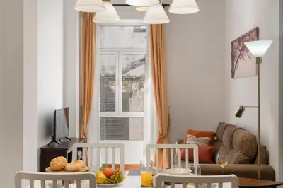 a living room with a table and chairs and a couch at Apartamento do Carmo by An Island Apart in Funchal