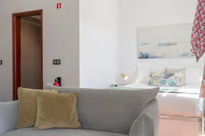 a living room with a bed and a couch at Apartamento do Carmo by An Island Apart in Funchal