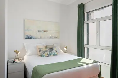 a bedroom with a bed and a window at Apartamento do Carmo by An Island Apart in Funchal