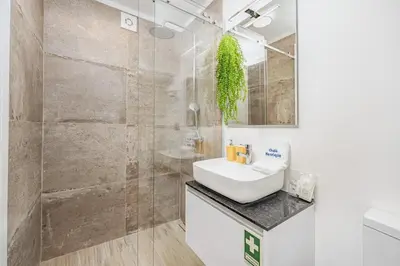 a bathroom with a sink and a shower at Chalé Henrique - Beachfront apartments at Calheta Beach in Calheta