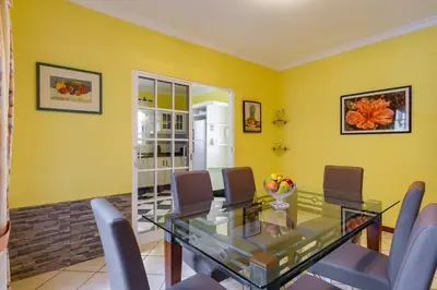 a dining room with a glass table and chairs at GuestReady - Peaceful Paradise in Madeira in Arco da Calheta