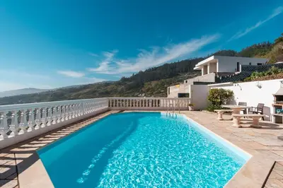 a swimming pool on a balcony with a view of the water at GuestReady - Peaceful Paradise in Madeira in Arco da Calheta