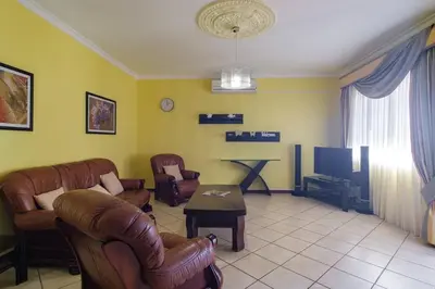 a living room with leather furniture and a tv at GuestReady - Peaceful Paradise in Madeira in Arco da Calheta