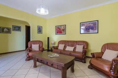 a living room with leather couches and a coffee table at GuestReady - Peaceful Paradise in Madeira in Arco da Calheta