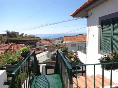 a balcony of a house with potted plants at Madeira Holiday Flats in Funchal