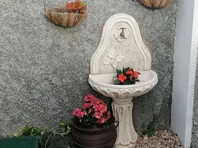 a white toilet sitting next to some flowers at Madeira Holiday Flats in Funchal