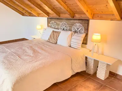 a bedroom with a large bed and two lamps at Calheta Bay View House - Family and Group Residence in Arco da Calheta