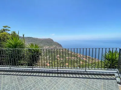 a balcony with a view of a mountain at Calheta Bay View House - Family and Group Residence in Arco da Calheta