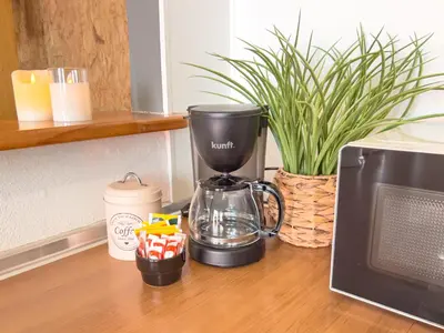 a coffee maker sitting on a counter next to a microwave at Calheta Bay View House - Family and Group Residence in Arco da Calheta