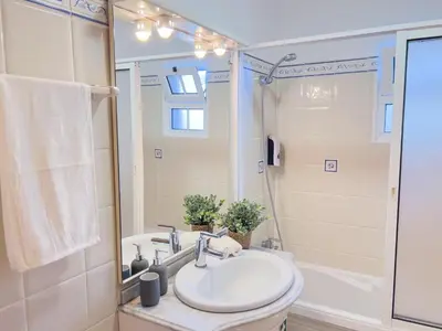 a bathroom with a white sink and a shower at Calheta Bay View House - Family and Group Residence in Arco da Calheta