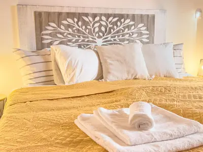 a bed with two towels on top of it at Calheta Bay View House - Family and Group Residence in Arco da Calheta