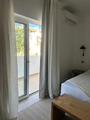 a bedroom with a bed and a sliding glass door at Casa Malìa Luxury Guest House in Luz