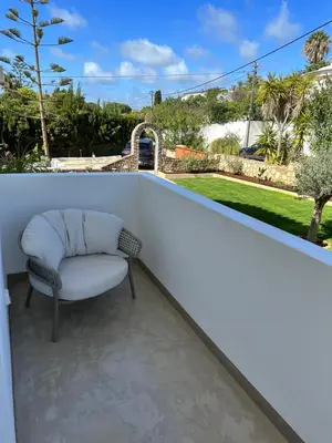 a chair sitting on the back of a balcony at Casa Malìa Luxury Guest House in Luz
