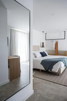 a bedroom with a bed and a mirror at Casa Malìa Luxury Guest House in Luz