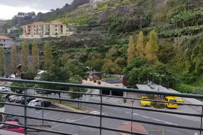 a view of a city with a train on a road at Comfy apt in the heart of Ponta do Sol in Ponta do Sol