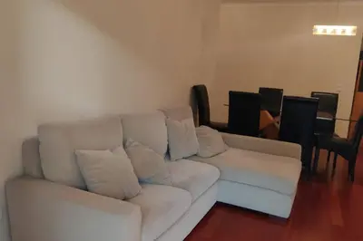 a white couch sitting in a living room at Comfy apt in the heart of Ponta do Sol in Ponta do Sol