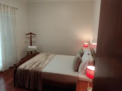 a bedroom with a bed with a candle on it at Sol e Mar in Ponta do Sol