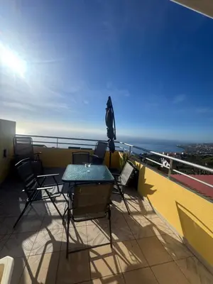 a patio with a table and chairs on a balcony at Betty House. in Santa Cruz