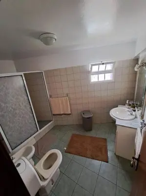a bathroom with a toilet and a sink at Betty House. in Santa Cruz