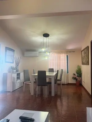 a dining room and living room with a table and chairs at Betty House. in Santa Cruz