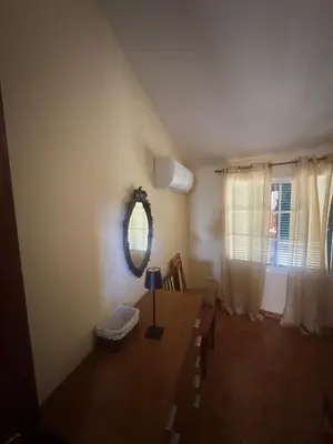 a dining room with a table and a mirror at Betty House. in Santa Cruz