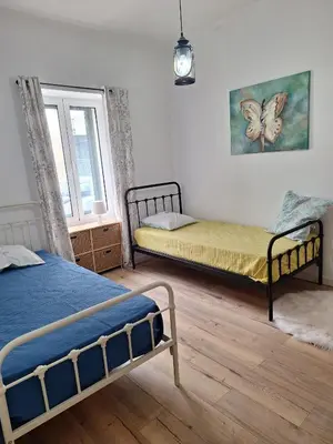 a bedroom with two beds and a window at Happy Stay Funchal in Funchal