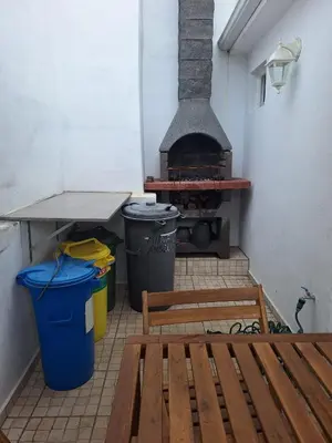 a room with a stove and a bench and trash cans at Happy Stay Funchal in Funchal