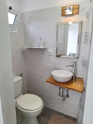 a bathroom with a white toilet and a sink at Happy Stay Funchal in Funchal