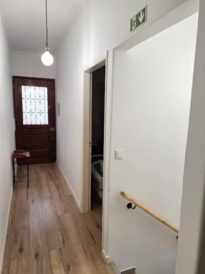 a hallway with white walls and a wooden floor at Happy Stay Funchal in Funchal